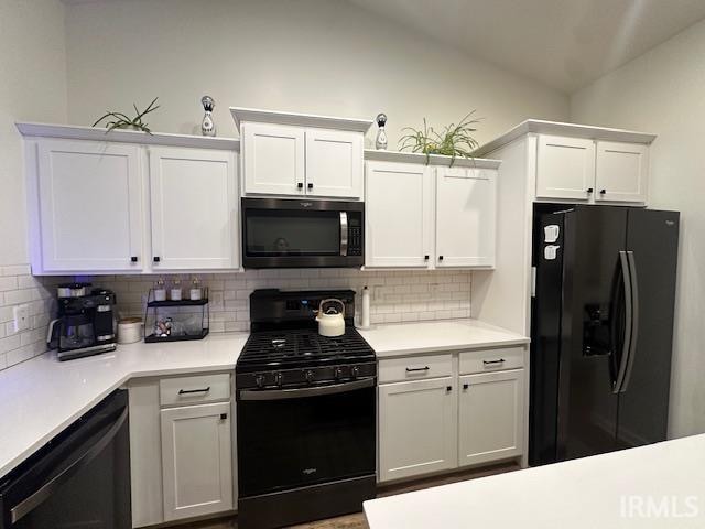 kitchen featuring decorative backsplash, white cabinets, and black appliances