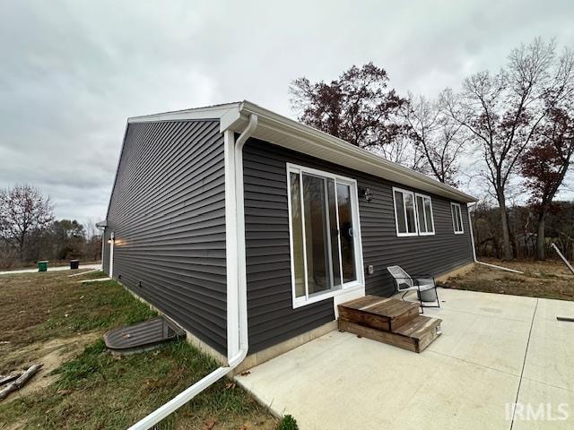 view of side of property featuring a patio area