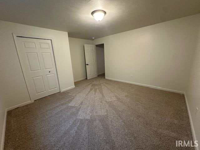 unfurnished bedroom featuring a closet and carpet floors