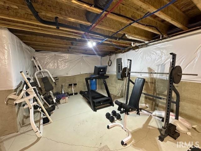 workout area featuring electric panel and concrete flooring