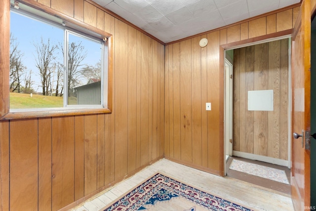 unfurnished room featuring wood walls and light wood-type flooring