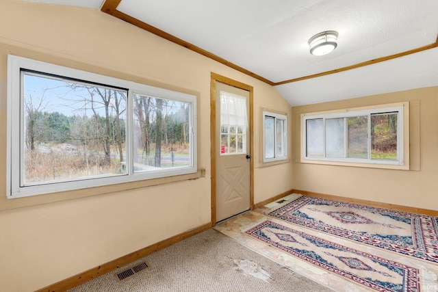 doorway with carpet and lofted ceiling