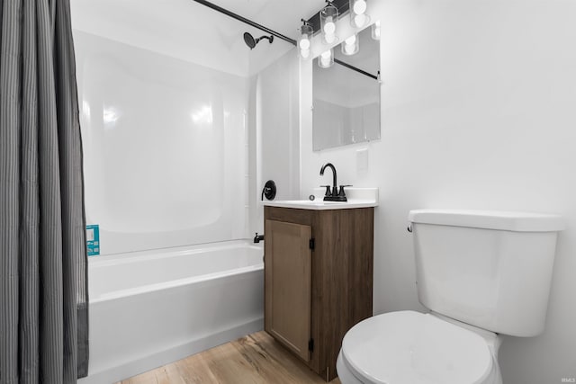 full bathroom featuring hardwood / wood-style flooring, vanity, toilet, and shower / tub combination