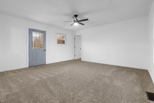 carpeted spare room with ceiling fan