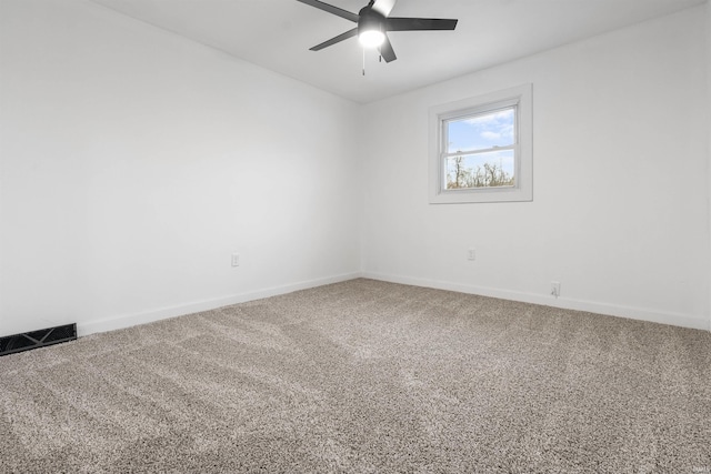 empty room with ceiling fan and carpet floors