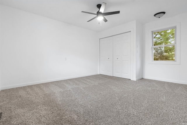 unfurnished bedroom with carpet flooring, ceiling fan, and a closet