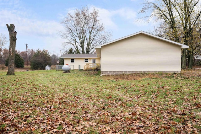 view of home's exterior with a lawn and a deck