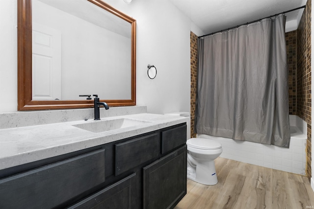 full bathroom featuring shower / bath combination with curtain, vanity, wood-type flooring, and toilet