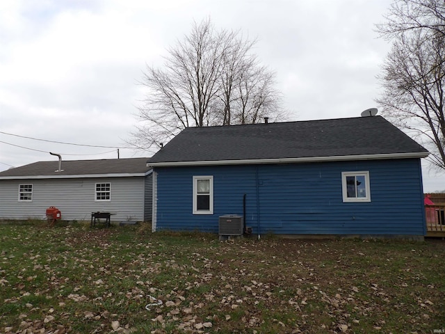 back of house with a yard and central air condition unit