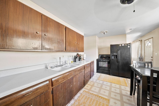 kitchen with sink and black appliances