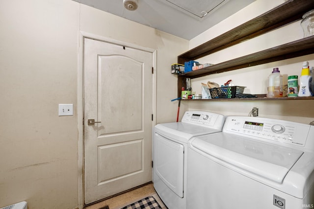 washroom with washing machine and dryer and light tile patterned flooring