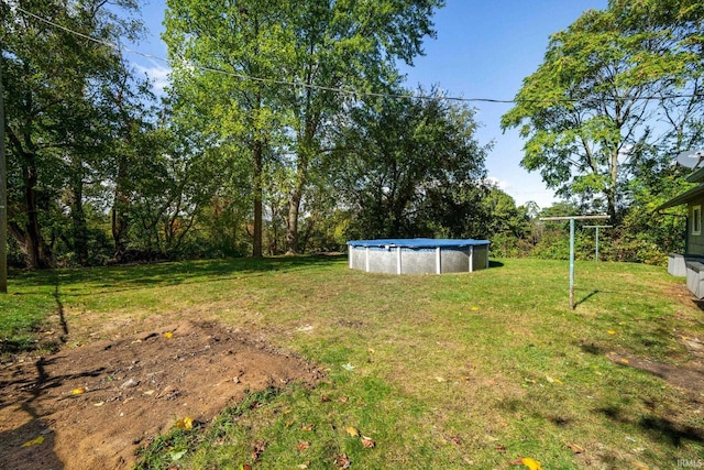 view of yard featuring a covered pool