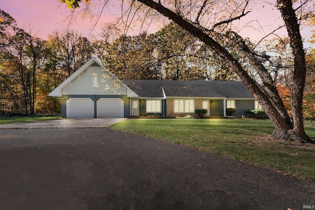 single story home with a lawn and a garage