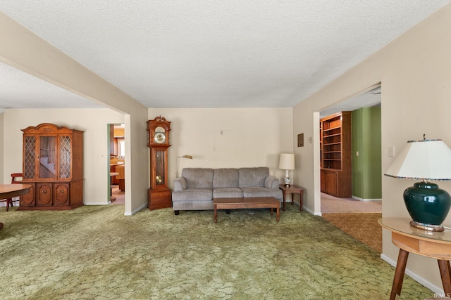 carpeted living room featuring a textured ceiling