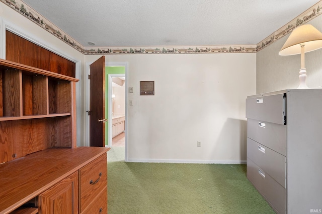 unfurnished office featuring a textured ceiling, dark carpet, and golf simulator