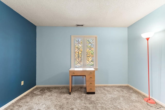 unfurnished office with light colored carpet and a textured ceiling