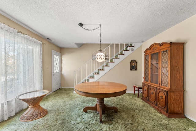 entrance foyer featuring carpet flooring and a textured ceiling