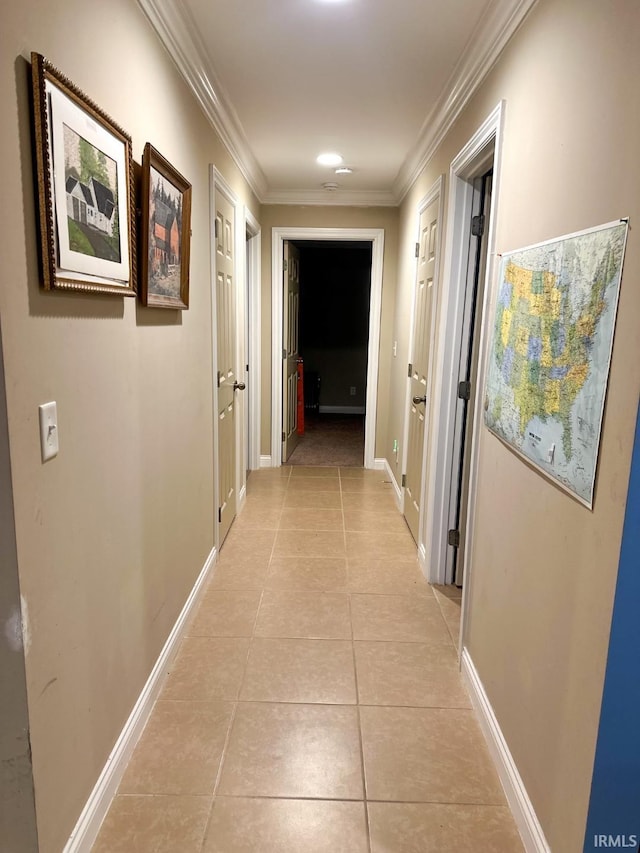 corridor featuring light tile patterned flooring and ornamental molding