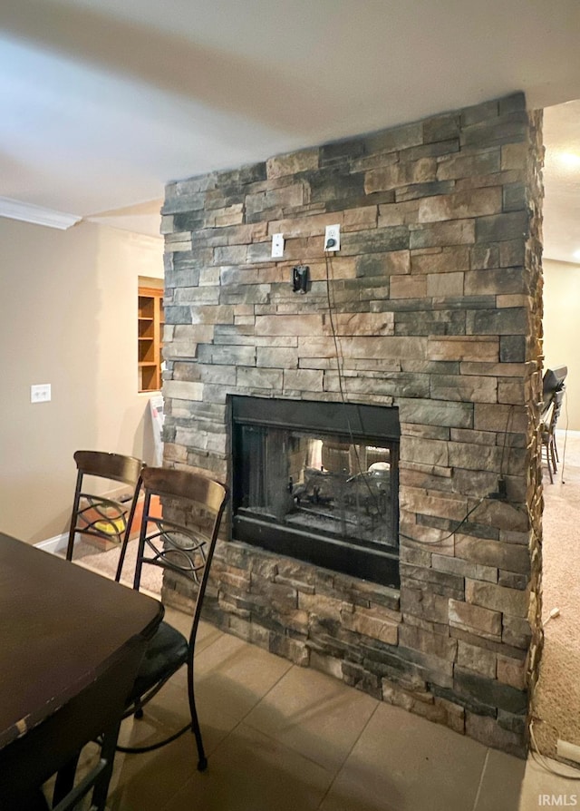 room details with a stone fireplace and ornamental molding