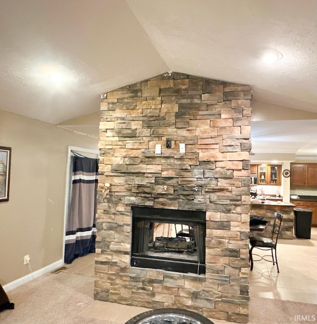 room details featuring a stone fireplace and carpet