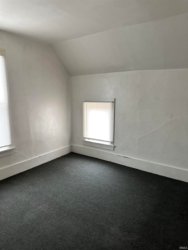 bonus room featuring carpet flooring and lofted ceiling