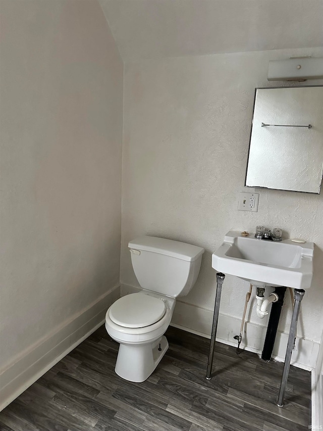 bathroom featuring wood-type flooring and toilet