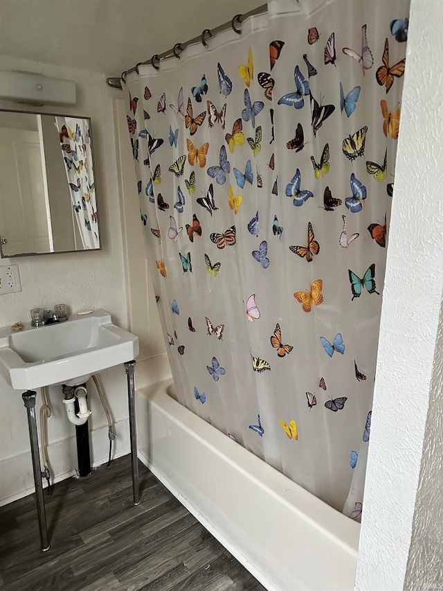 bathroom featuring wood-type flooring and shower / bath combo