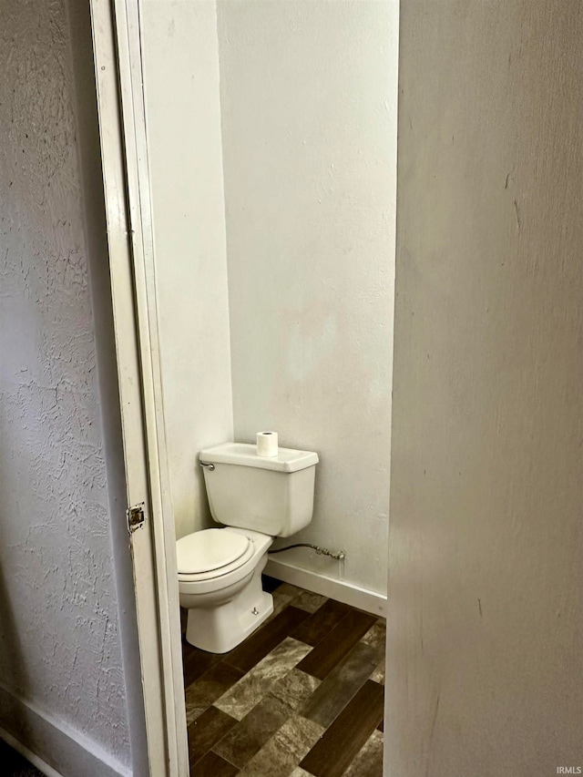 bathroom featuring hardwood / wood-style floors and toilet