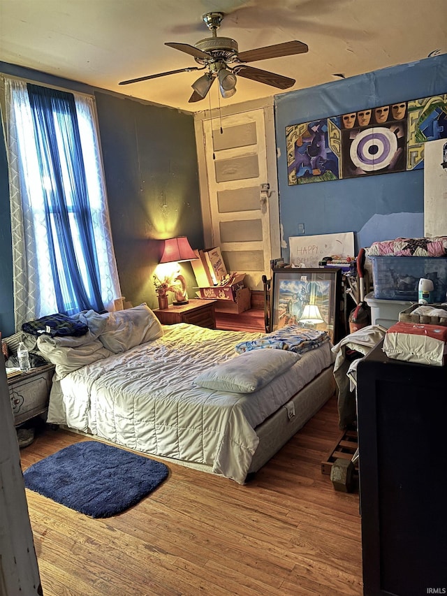 bedroom featuring wood finished floors and ceiling fan