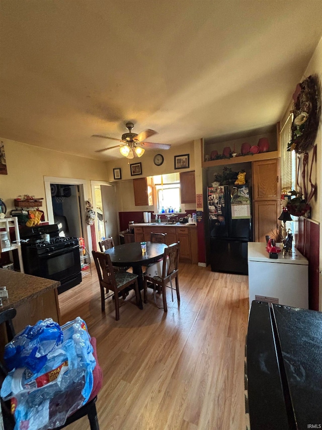 dining room with plenty of natural light, light wood-style floors, and ceiling fan