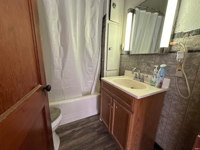 full bathroom with decorative backsplash, vanity, shower / tub combo with curtain, wood-type flooring, and toilet