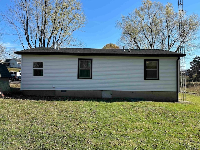 view of side of property with a lawn