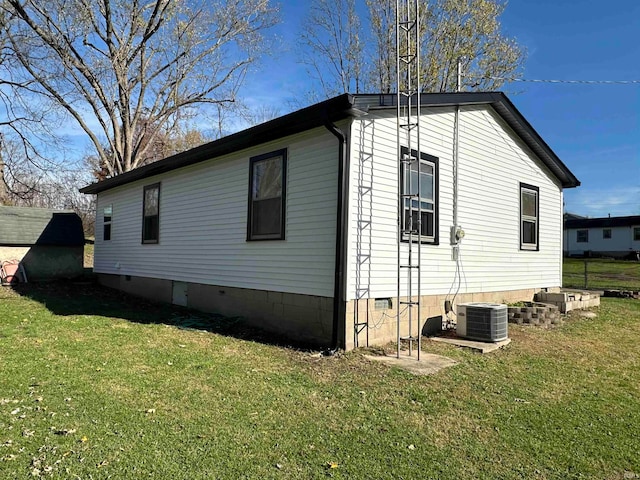 view of home's exterior featuring central air condition unit and a lawn