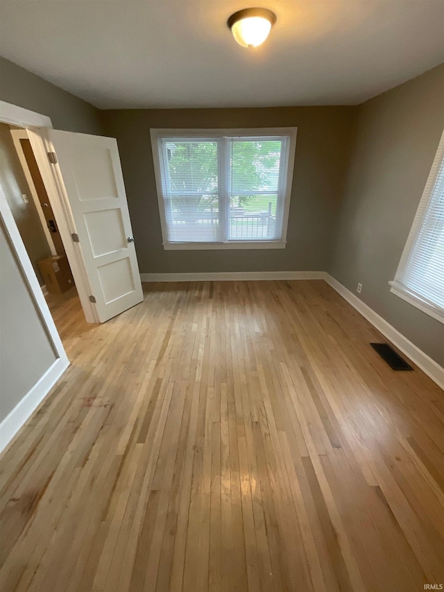 spare room featuring light hardwood / wood-style floors