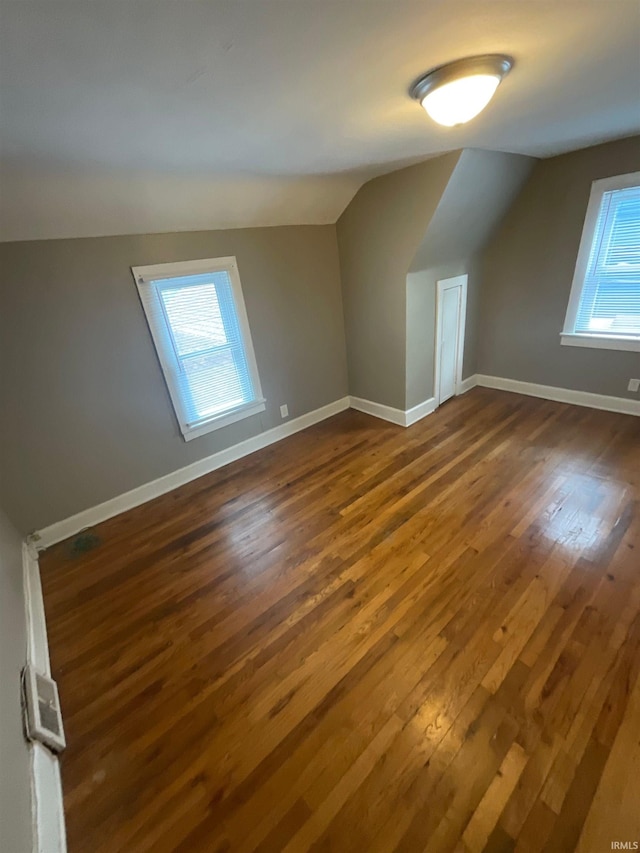 additional living space with dark hardwood / wood-style flooring and lofted ceiling