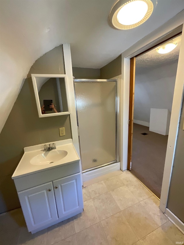 bathroom featuring tile patterned flooring, vanity, and walk in shower