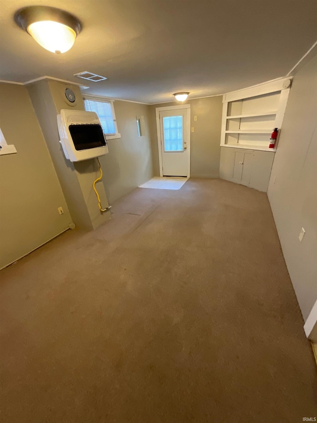 basement featuring carpet floors and heating unit