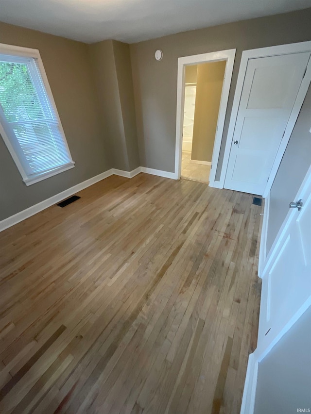 empty room with light hardwood / wood-style floors