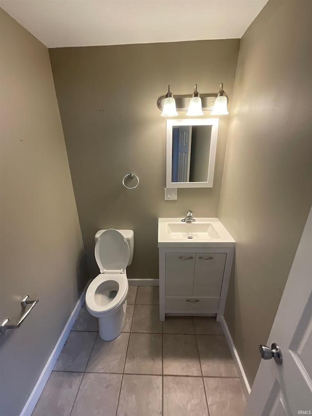 bathroom featuring tile patterned flooring, vanity, and toilet