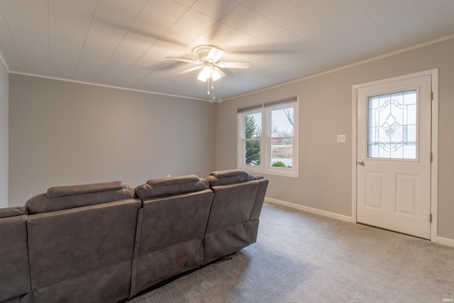 carpeted living room with ceiling fan and ornamental molding