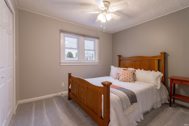 bedroom with ceiling fan, a closet, and light colored carpet