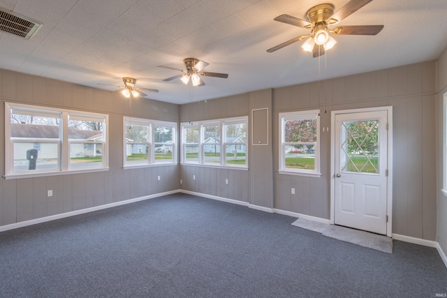 unfurnished room featuring dark colored carpet and ceiling fan