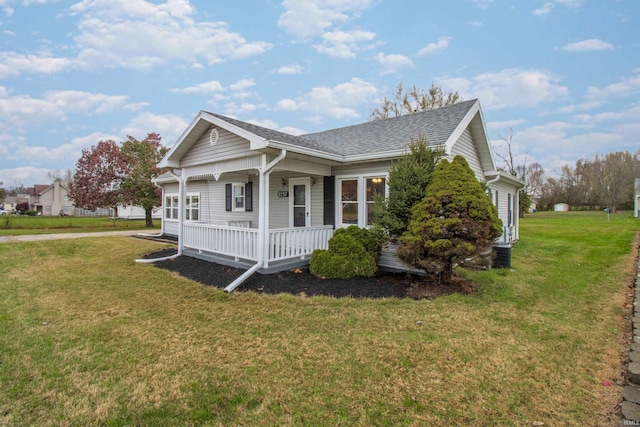 view of side of property featuring a yard and covered porch