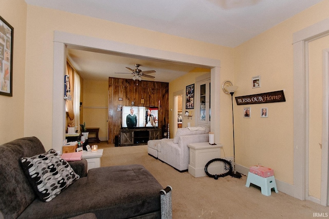 living room with ceiling fan and light colored carpet