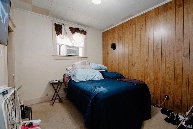 bedroom featuring light carpet, ornamental molding, and wood walls