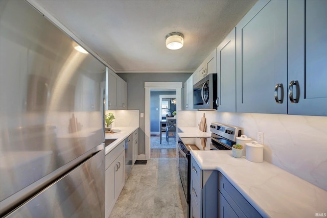 kitchen featuring light stone counters, ornamental molding, light wood-type flooring, and appliances with stainless steel finishes