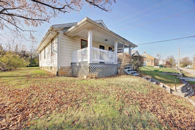 view of home's exterior featuring a yard and covered porch