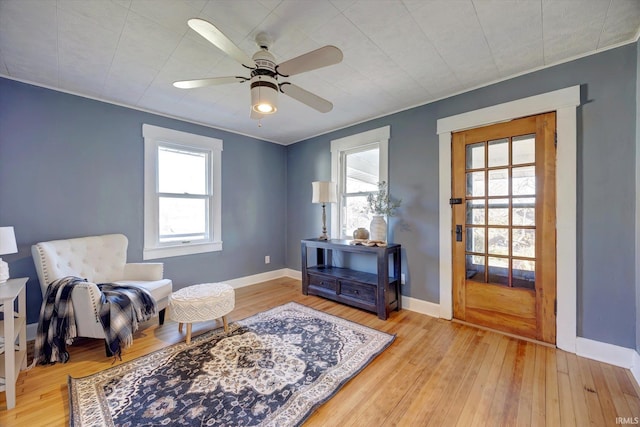 sitting room with light hardwood / wood-style floors and ceiling fan