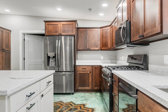 kitchen featuring light stone countertops, white cabinets, stainless steel appliances, and lofted ceiling