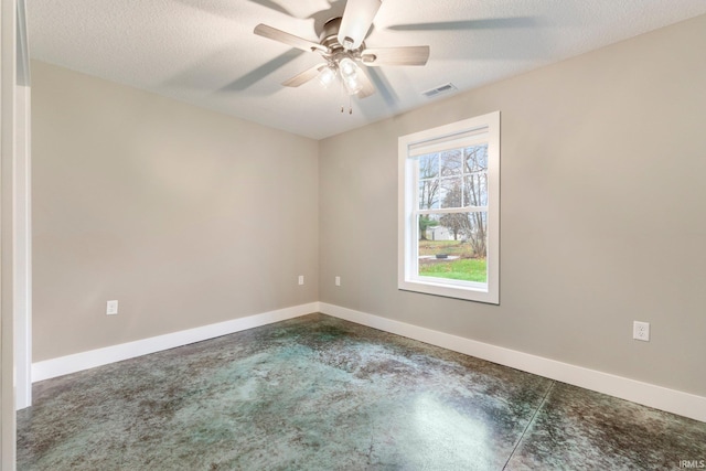 unfurnished room featuring ceiling fan and a textured ceiling